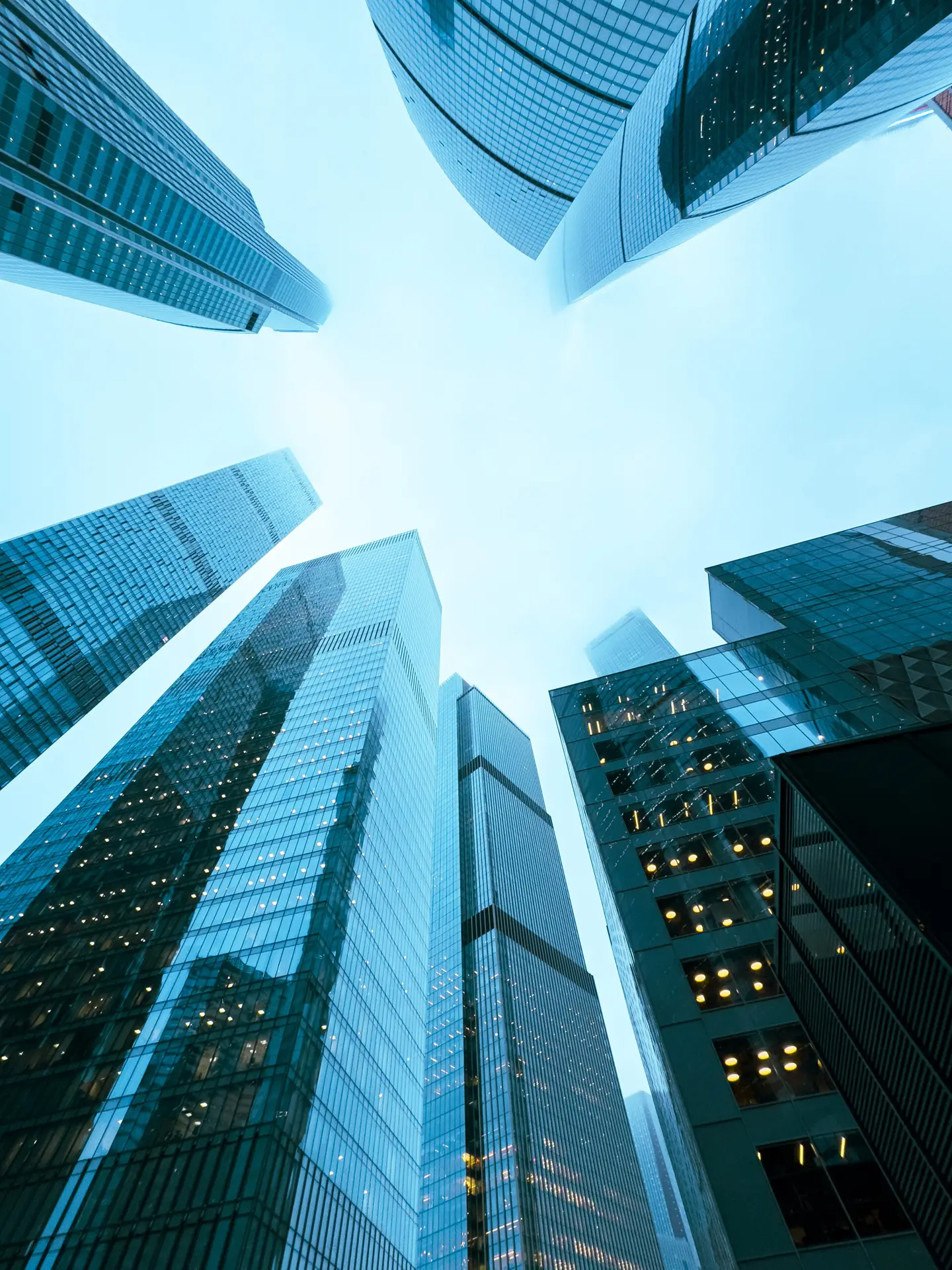 a city skyline with tall buildings and a clear blue sky